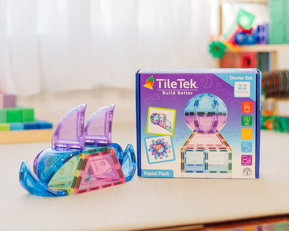 Colorful magnetic building tiles and their packaging on a table.
