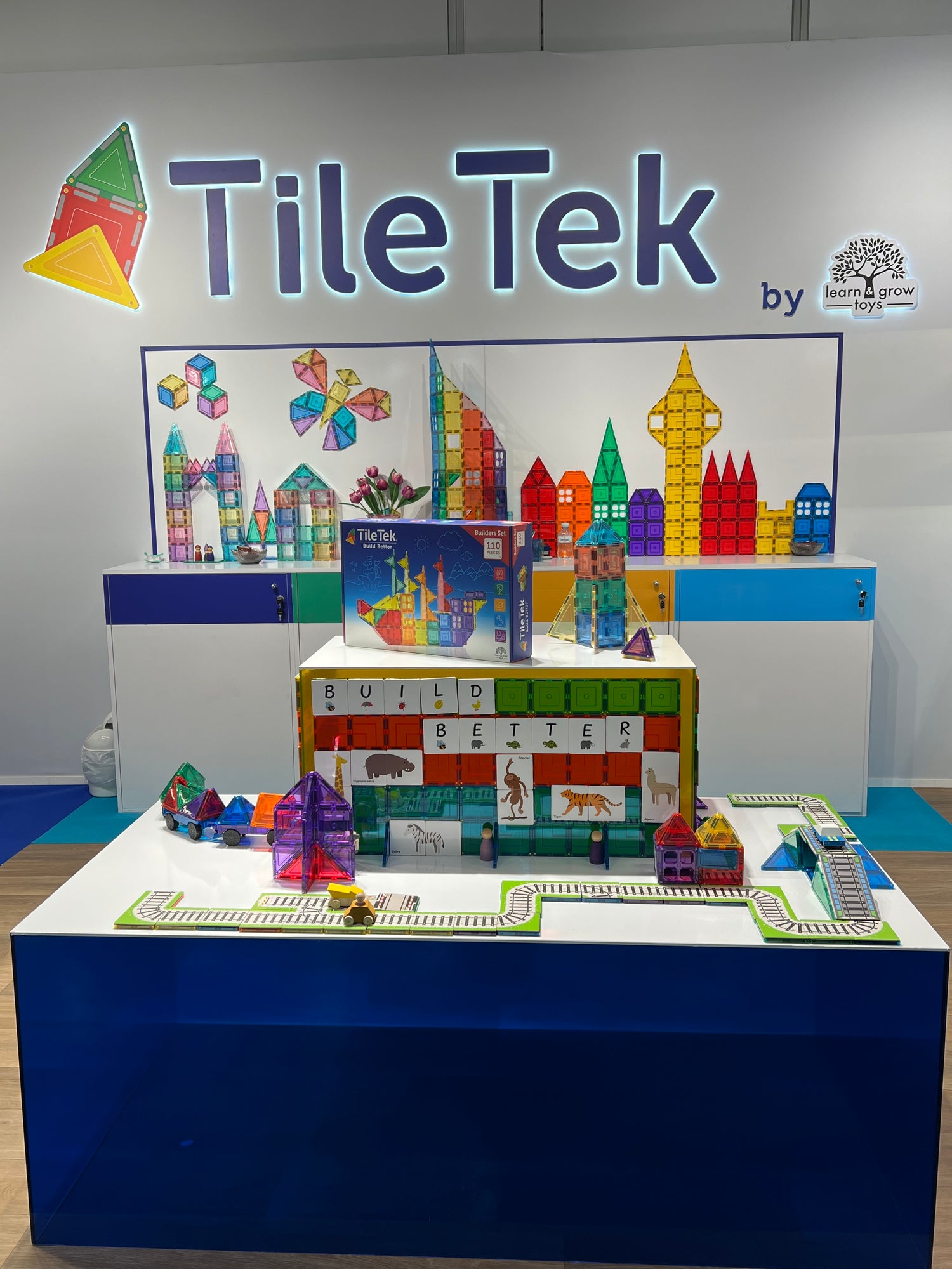 TileTek display with colourful building blocks and educational materials on a stand.